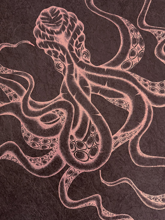 Textural close-up of Kraken Claret wallpaper with shimmering gold iridescence and bold octopus artwork