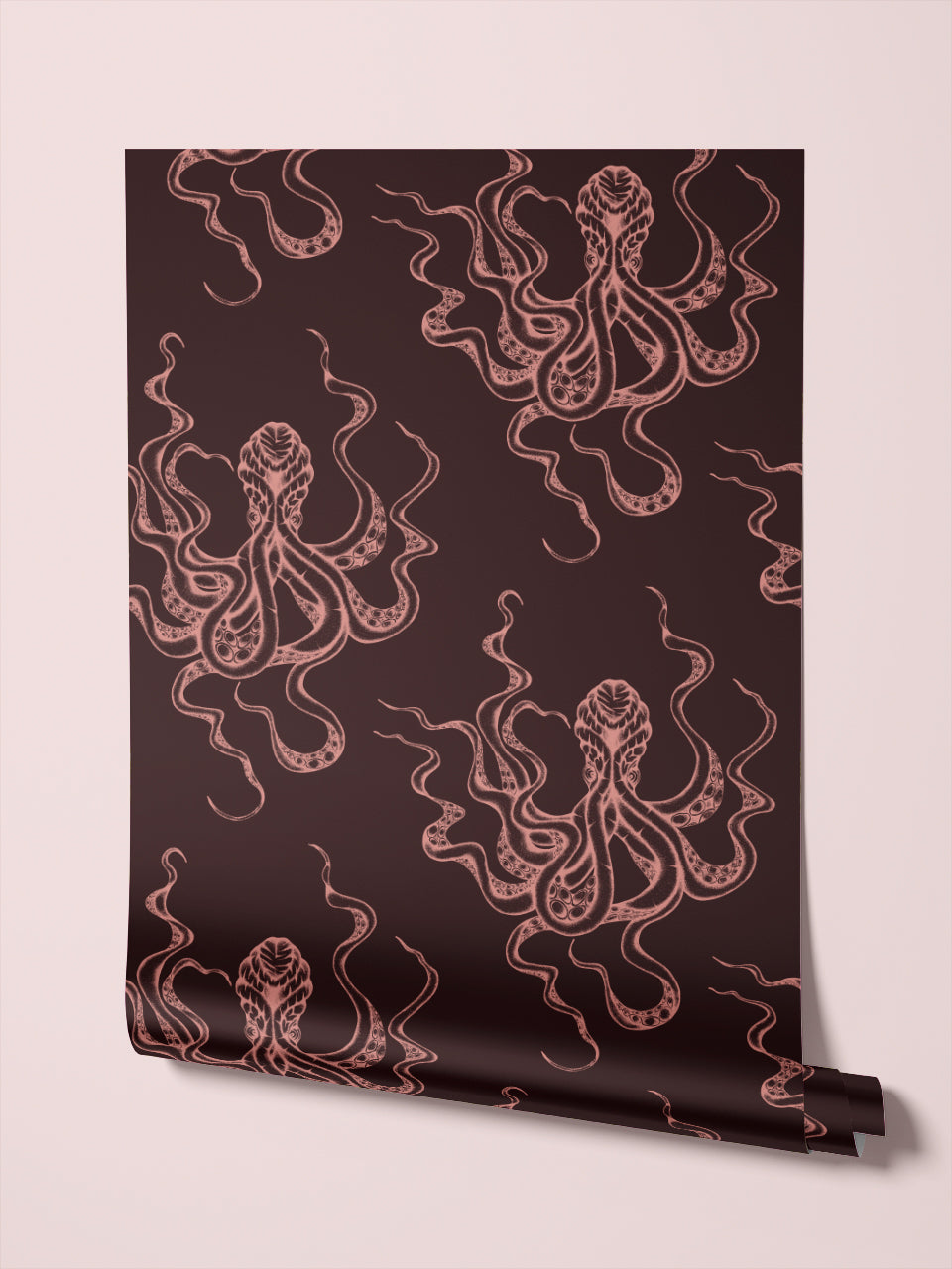 Roll of Kraken Claret wallpaper with pink octopus motif, displayed against a blush backdrop for nautical interiors