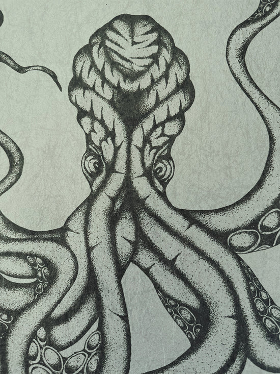 Dramatic close-up of Kraken’s head and eye in graphite ink on parchment-style background.
