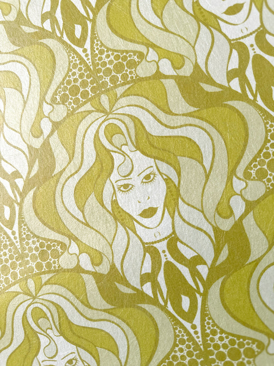 Feminine portrait-style wallpaper with olive detail and parchment print on gold base.