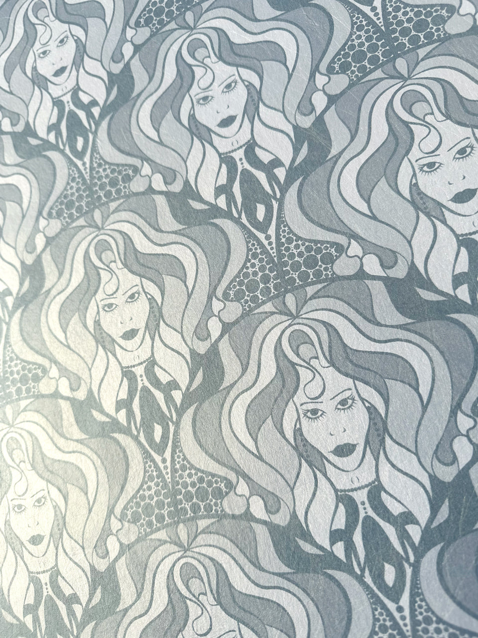 Ash-toned silver wallpaper with gilded 70s diva repeat and maximalist retro flair.