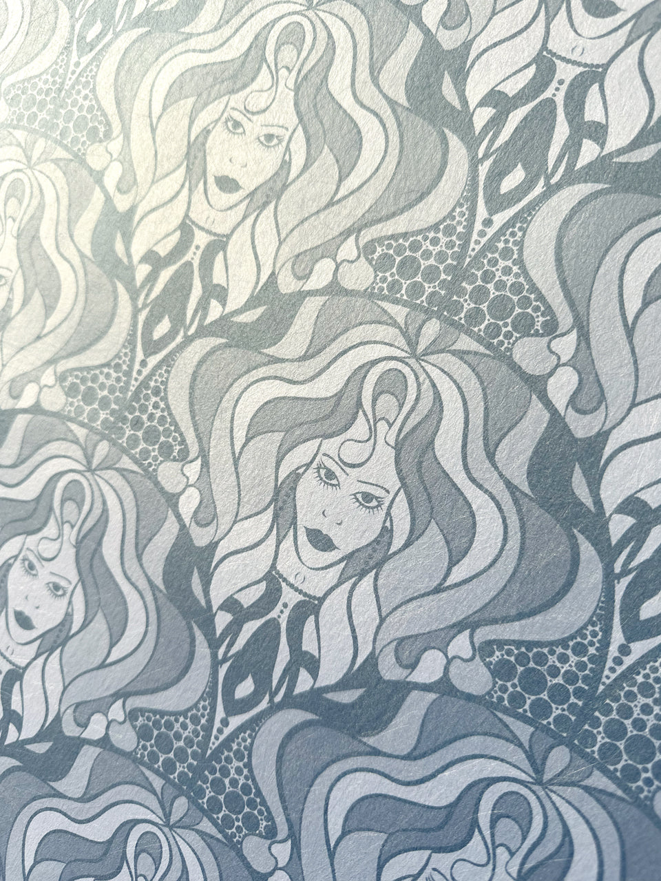 Detailed view of diva-inspired wallpaper with bold, feminine linework and silver shimmer.