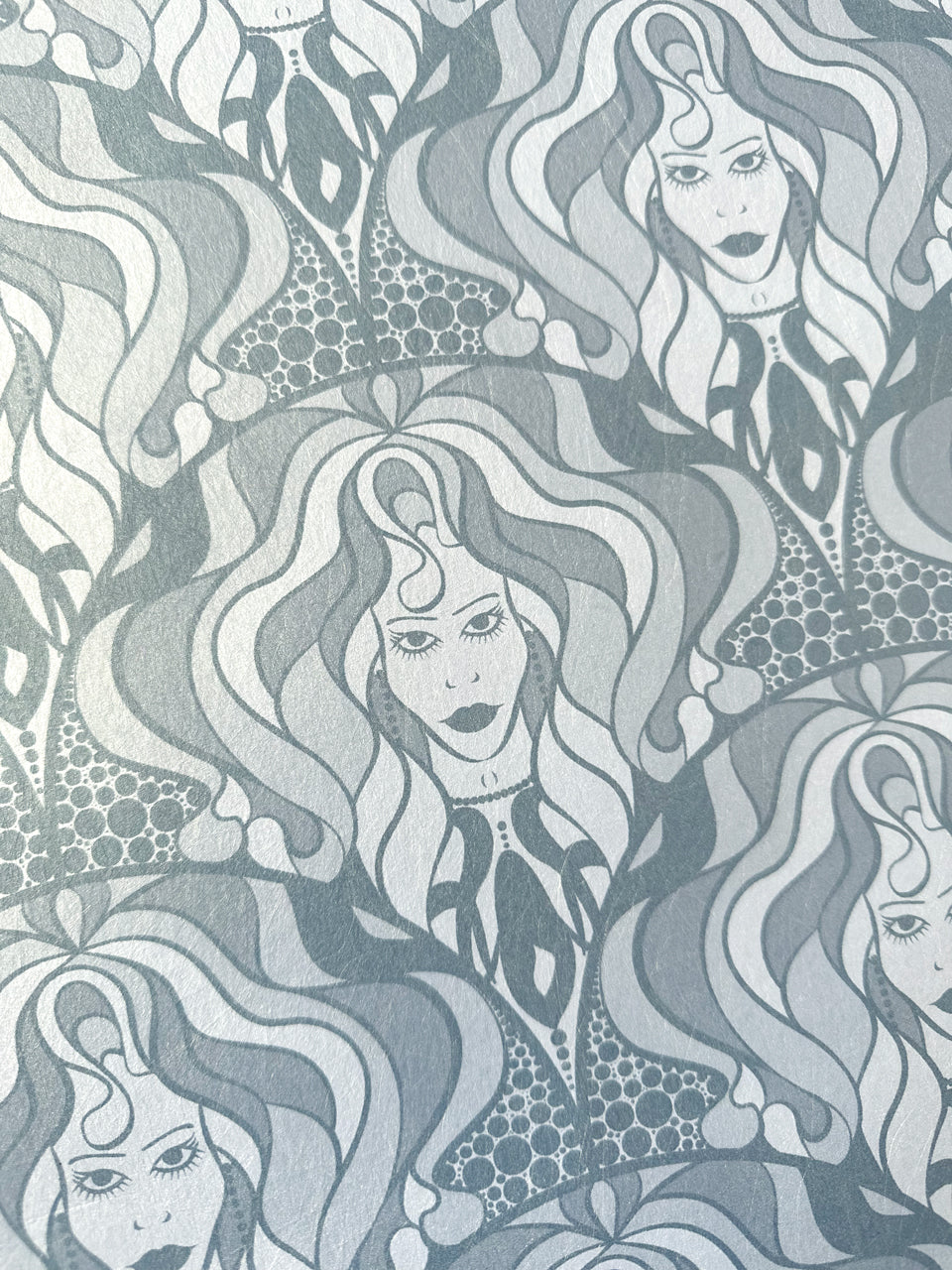 Iridescent wallpaper featuring hand-drawn divas and an Art Nouveau twist in silver tones.