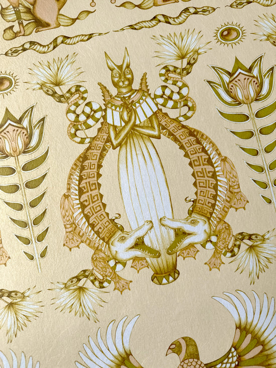 Detail of crocodile print from the Egyptian-inspired Nefertiti Cream wallpaper with luxe gold tones.