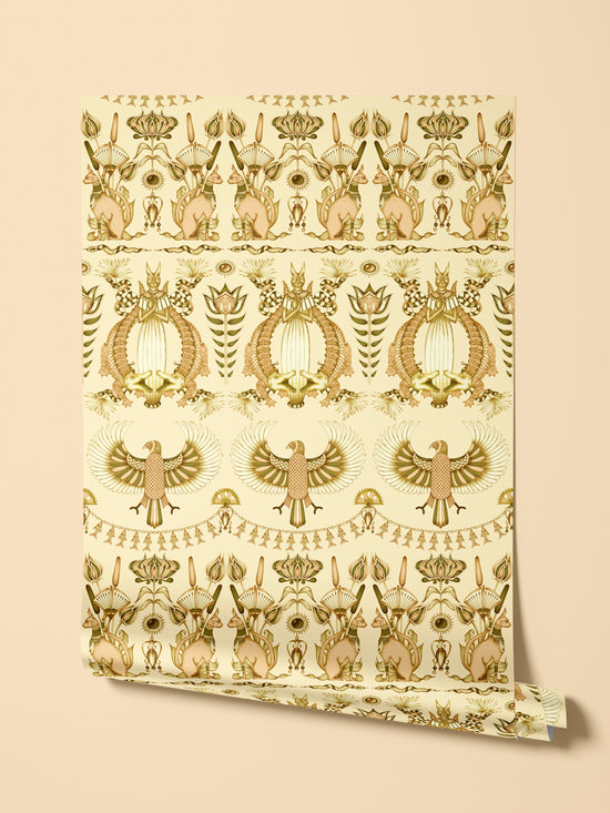 Hanging roll of Nefertiti Cream wallpaper with gold floral accents in a luxury cream palette.