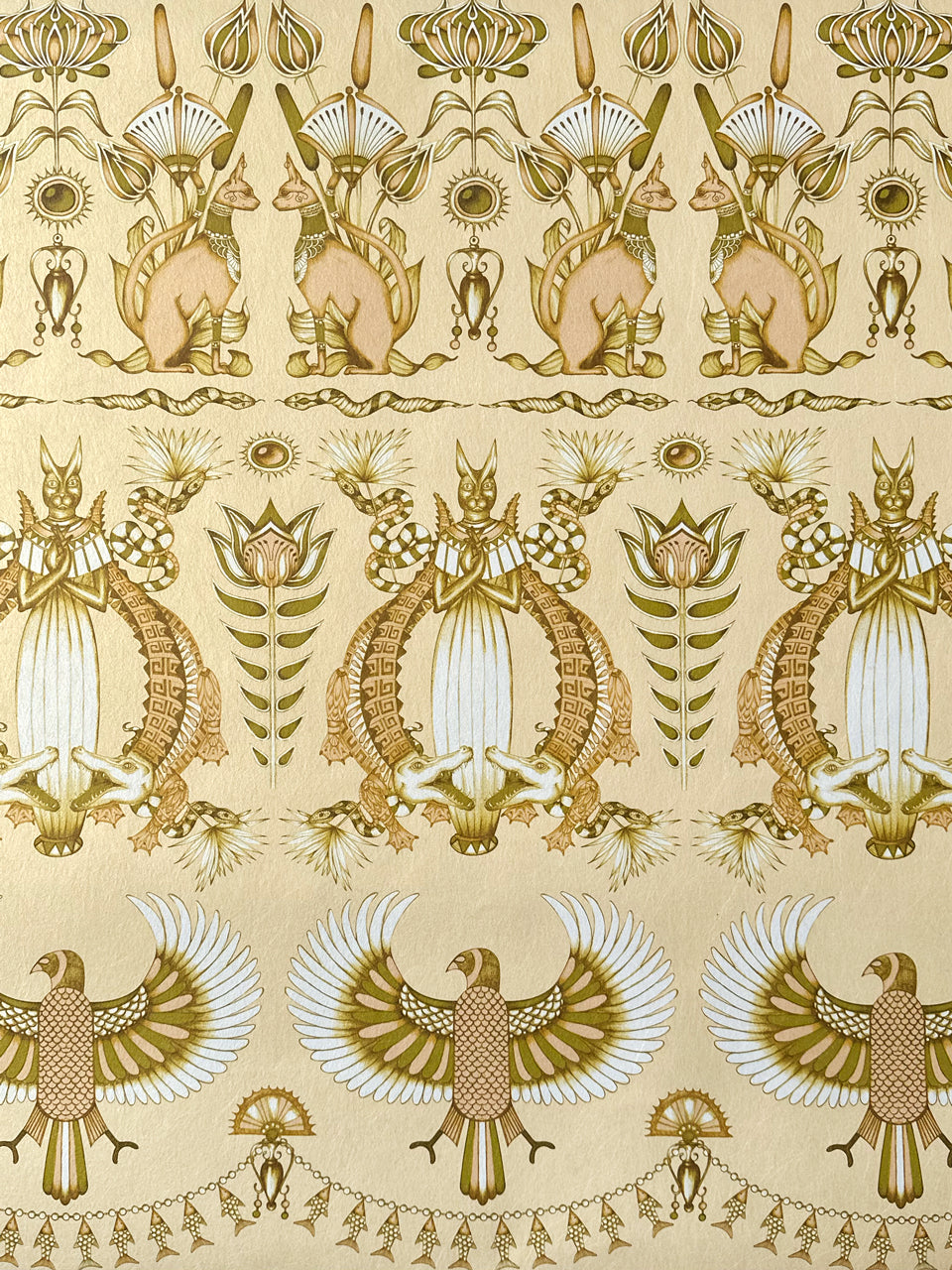 Close-up of Nefertiti Cream wallpaper showing opulent gold detail with fish, florals, and palms.