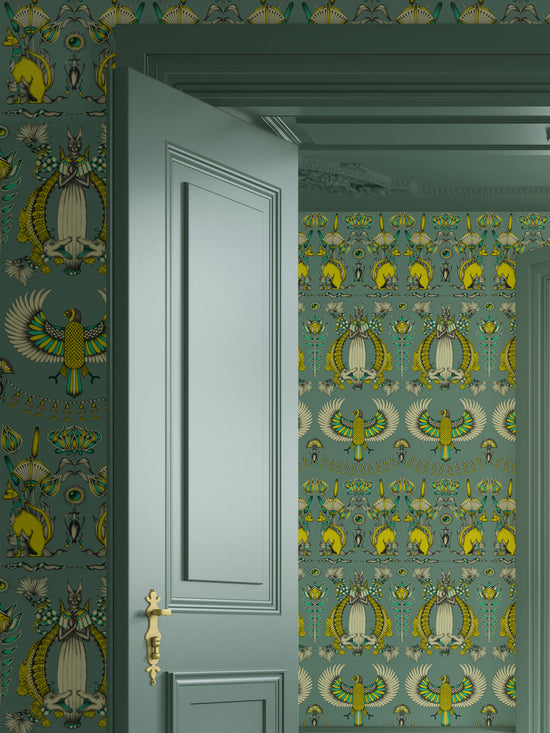 Egyptian-inspired Green Grey wallpaper used in a luxurious bedroom with eucalyptus and gold tones.