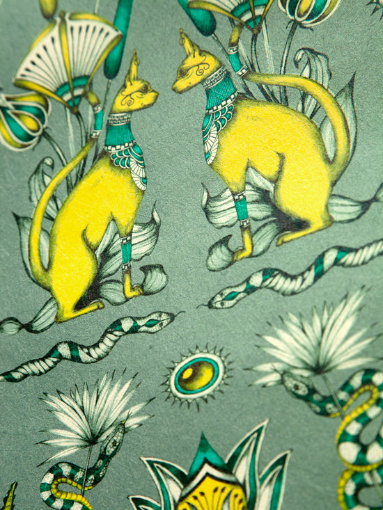 Egyptian cats and snakes amid eucalyptus-hued detailing on the opulent Green Grey Nefertiti wallpaper.