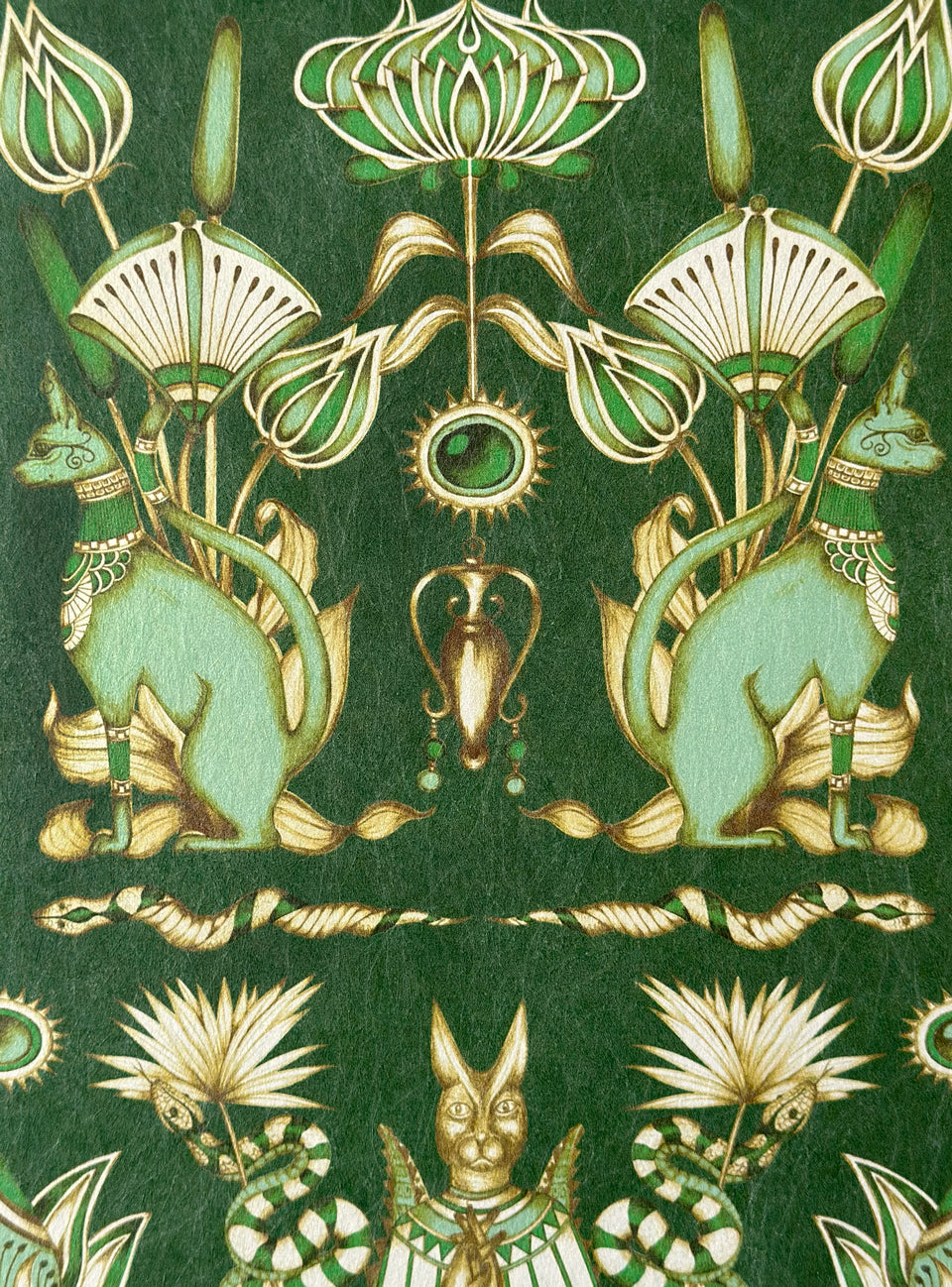 Metallic gold detailing on Nefertiti Green wallpaper with Egyptian cats and snakes in emerald tones.