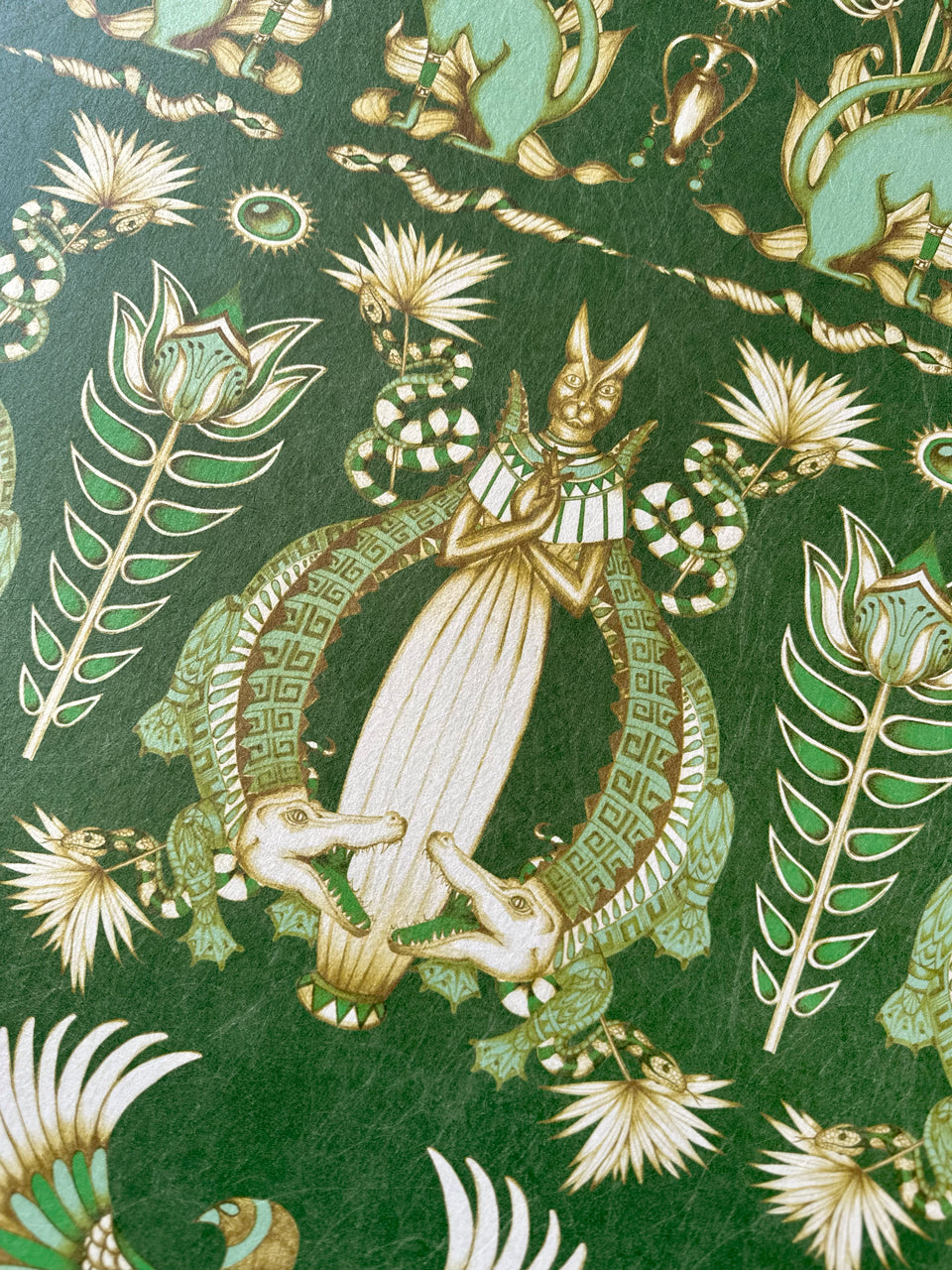 Art deco inspired crocodile motifs on Nefertiti Green wallpaper with metallic gold accents.