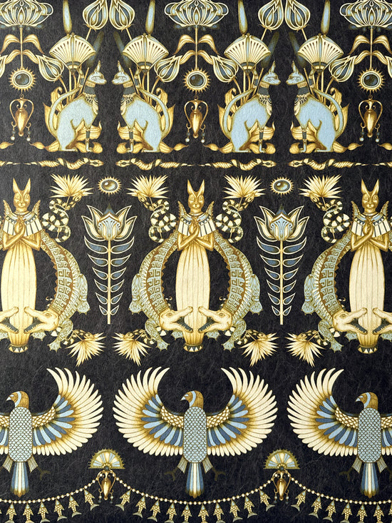 Close-up of Nefertiti Navy wallpaper featuring sacred cats, crocodiles, and Egyptian motifs in dark navy and gold.