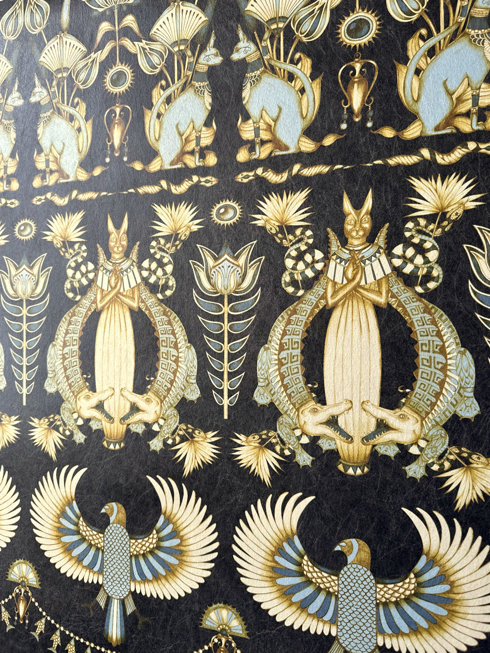 Close-up of duck egg and gold Nefertiti Navy wallpaper with sacred cats and exotic birds.