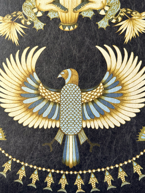 Art Deco winged bird motif in gold and ice blue on Nefertiti Navy wallpaper.