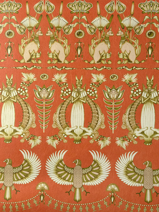 Close-up of Nefertiti Orange wallpaper showing Egyptian cats and papyrus in earthy orange tones.