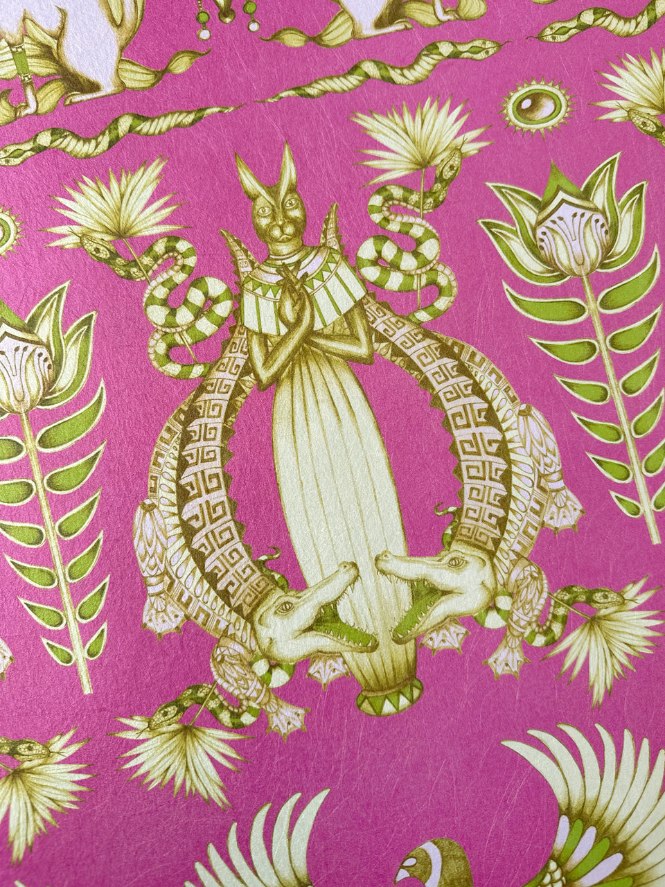 Crocodile and serpent print in olive green on gold-backed Nefertiti Pink wallpaper inspired by ancient myths.