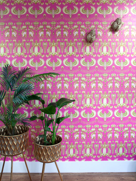 Maximalist statement feature wall showcasing the full Nefertiti Pink wallpaper design in gold and fuchsia.