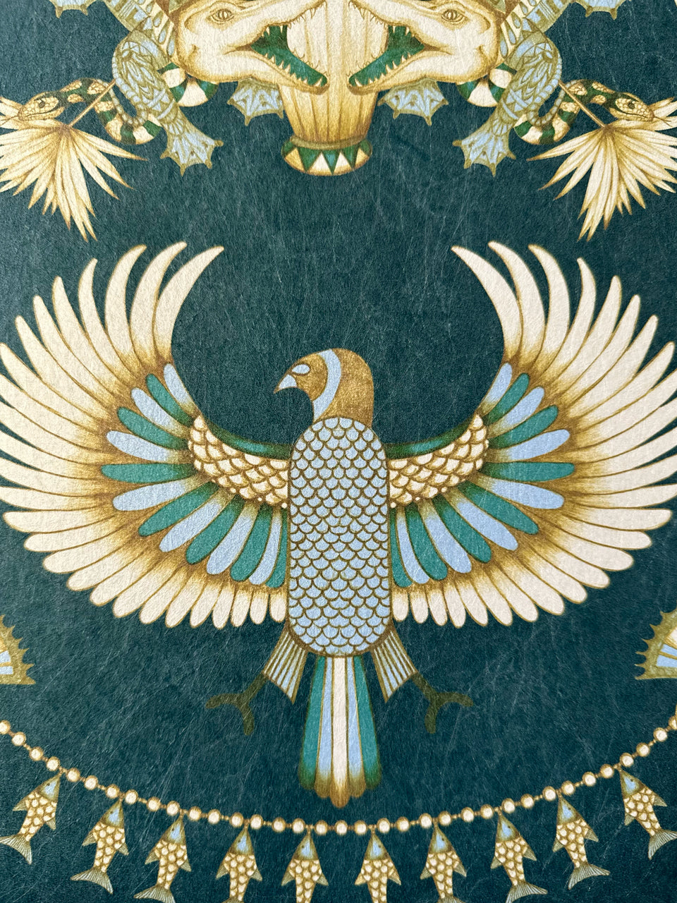 Bird and fish details in duck egg and metallic gold on Egyptian deco-style wallpaper.