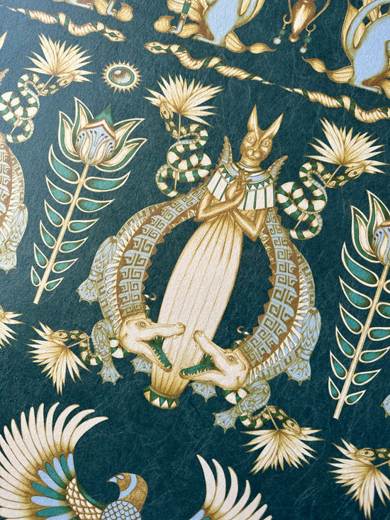 Hand-drawn crocodile and floral elements in cream and gold on an Egyptian-style wallpaper.