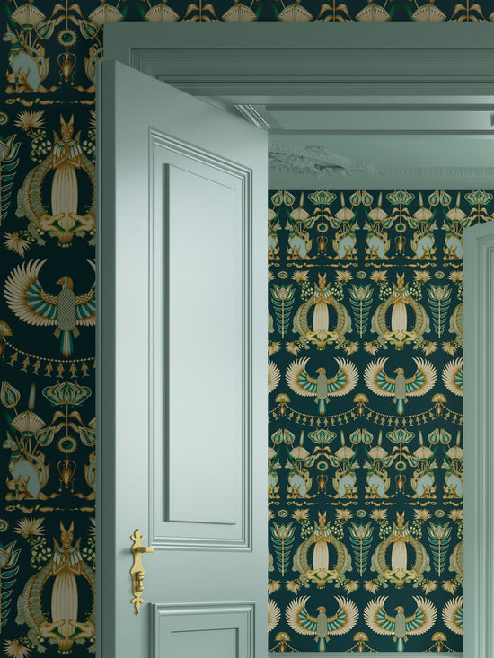 Maximalist bedroom wallpaper with designer Egyptian motifs and metallic gold detail.