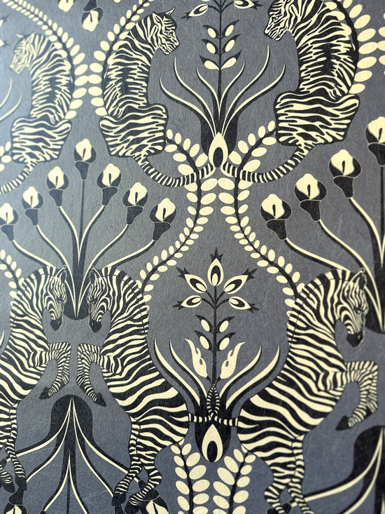 Gold foil effect highlights tiger and zebra animal print on Secret Garden Safari Black wallpaper.
