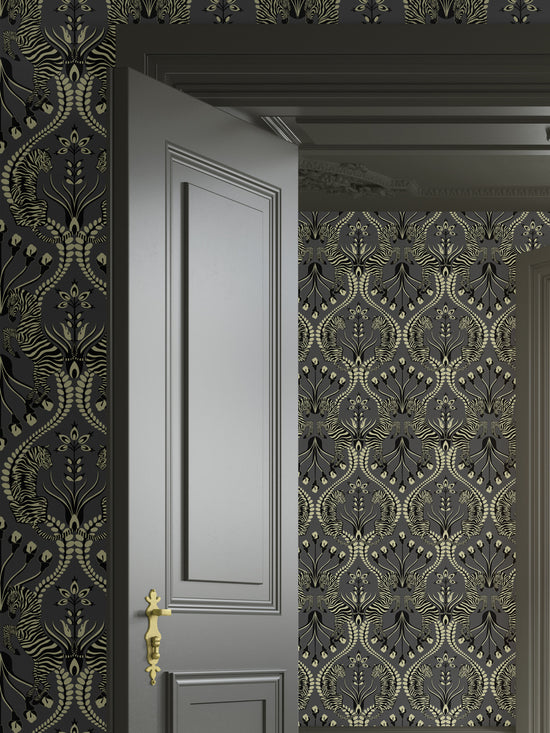 Tiger and zebra print wallpaper in a bedroom setting with warm gold glow, Secret Garden Safari Black.