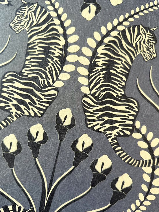 Tiger detail in dark pewter tones with floral print on Secret Garden Safari Black wallpaper.