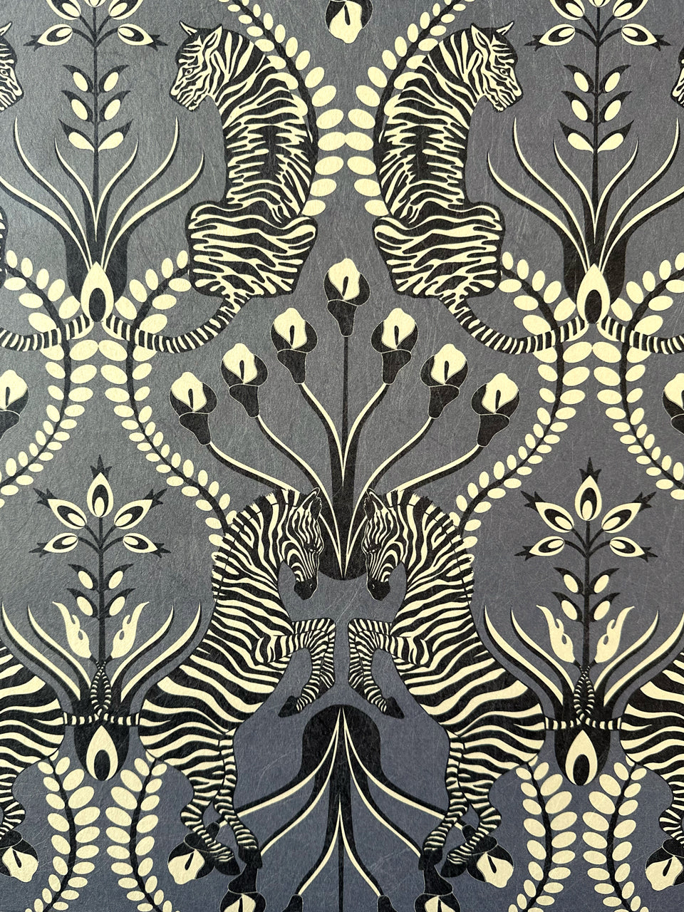 Opulent black wallpaper close-up showing zebra, tiger, and velvet black floral accents from Secret Garden Safari.