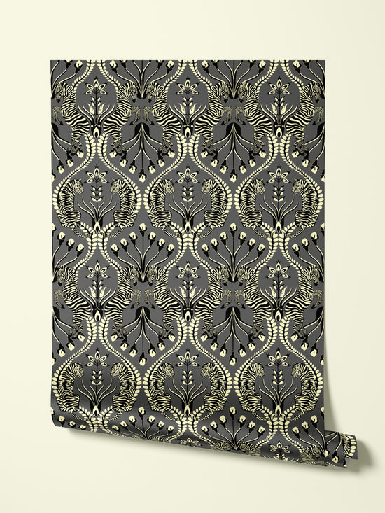 Hanging roll of Secret Garden Safari Black wallpaper with iridescent gold and folk floral design.