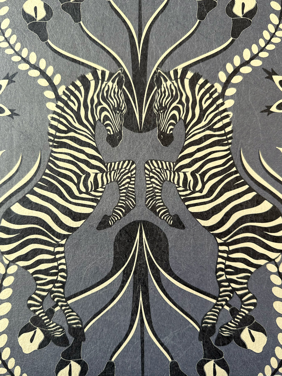 Zebra pattern detail in smoky slate tones on Secret Garden Safari Black wallpaper with floral elements.