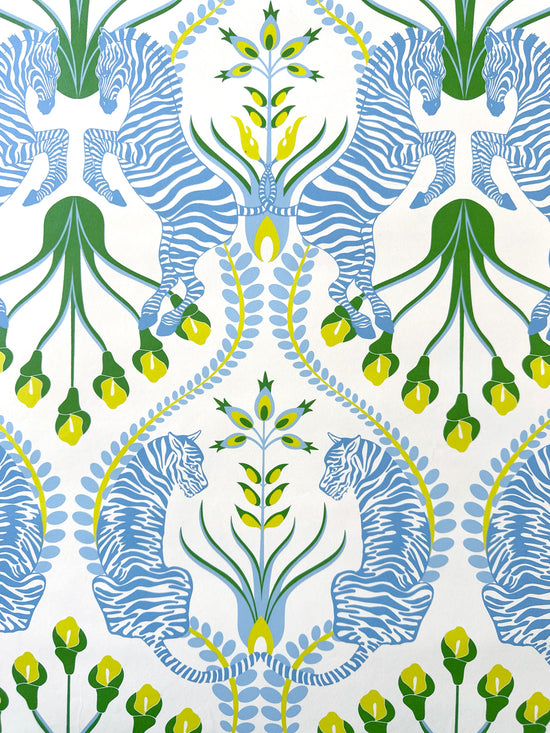 Luxury close-up of Secret Garden Safari Blue showing yellow folk florals, zebra and tiger design details.