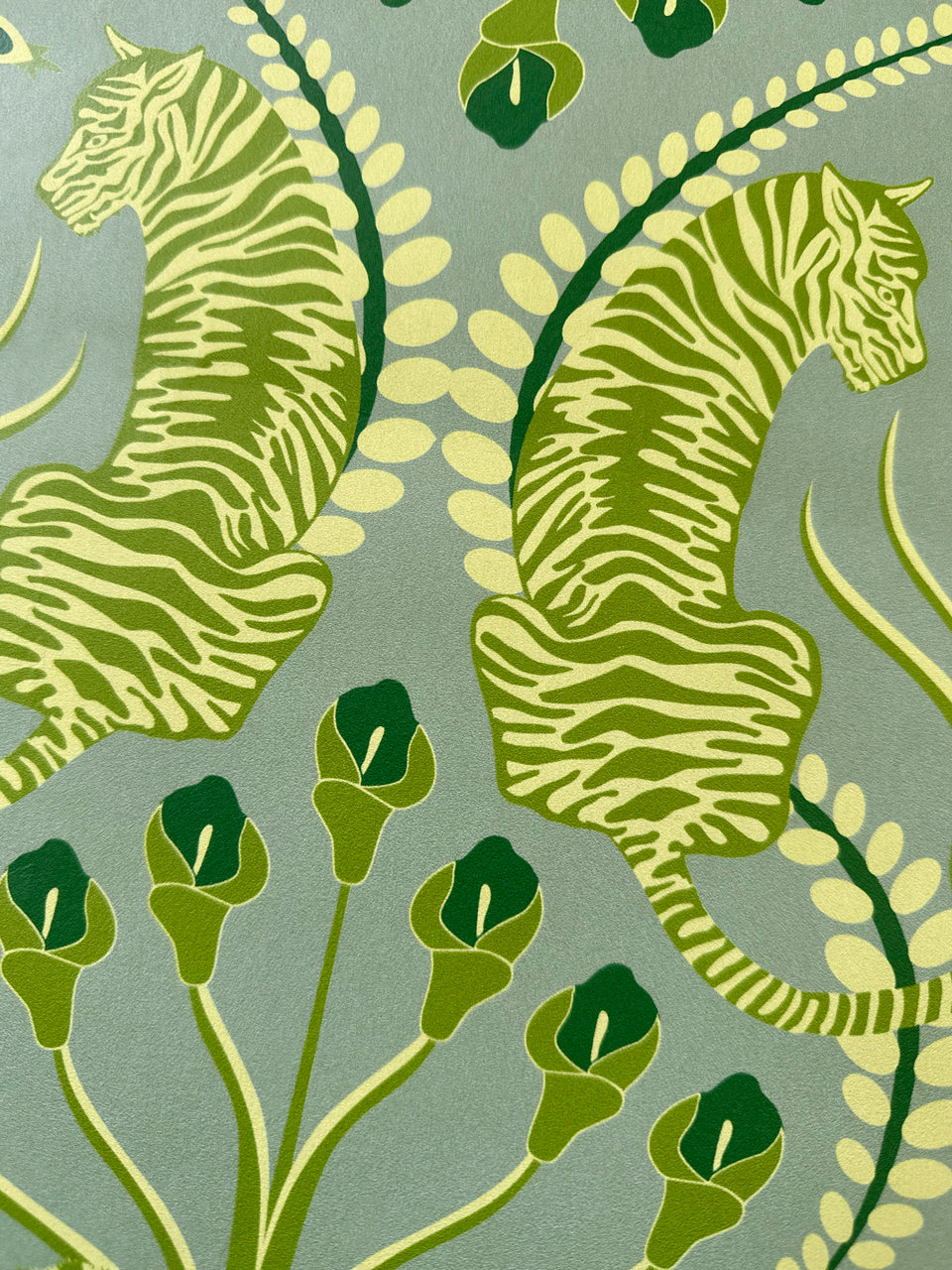 Close-up of tiger motif in Secret Garden Safari Green wallpaper, styled with heritage flair in a soft olive and moss palette.