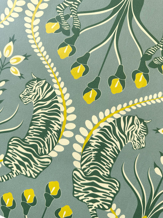 Detailed view of tiger motif on Secret Garden Safari Grey wallpaper with botanical elements in ochre and eucalyptus.