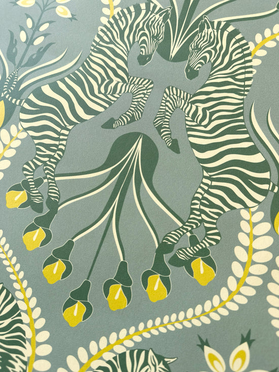 Secret Garden Safari Grey wallpaper with rearing zebras and folk-style florals in eucalyptus and mustard.