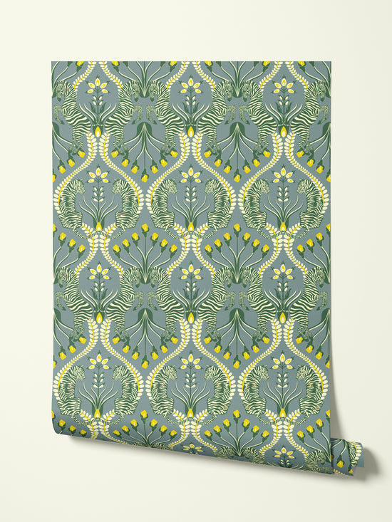 Rolled wallpaper sample of Secret Garden Safari Grey showing floral design in neutral, eucalyptus, and mustard tones.