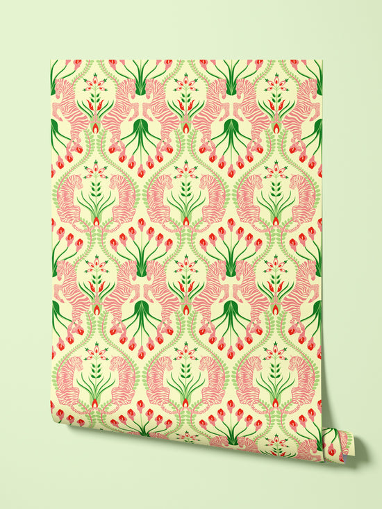 Hanging roll of Secret Garden Safari wallpaper in Pink, showcasing pistachio greens, rosy florals, and luxury pattern detail.