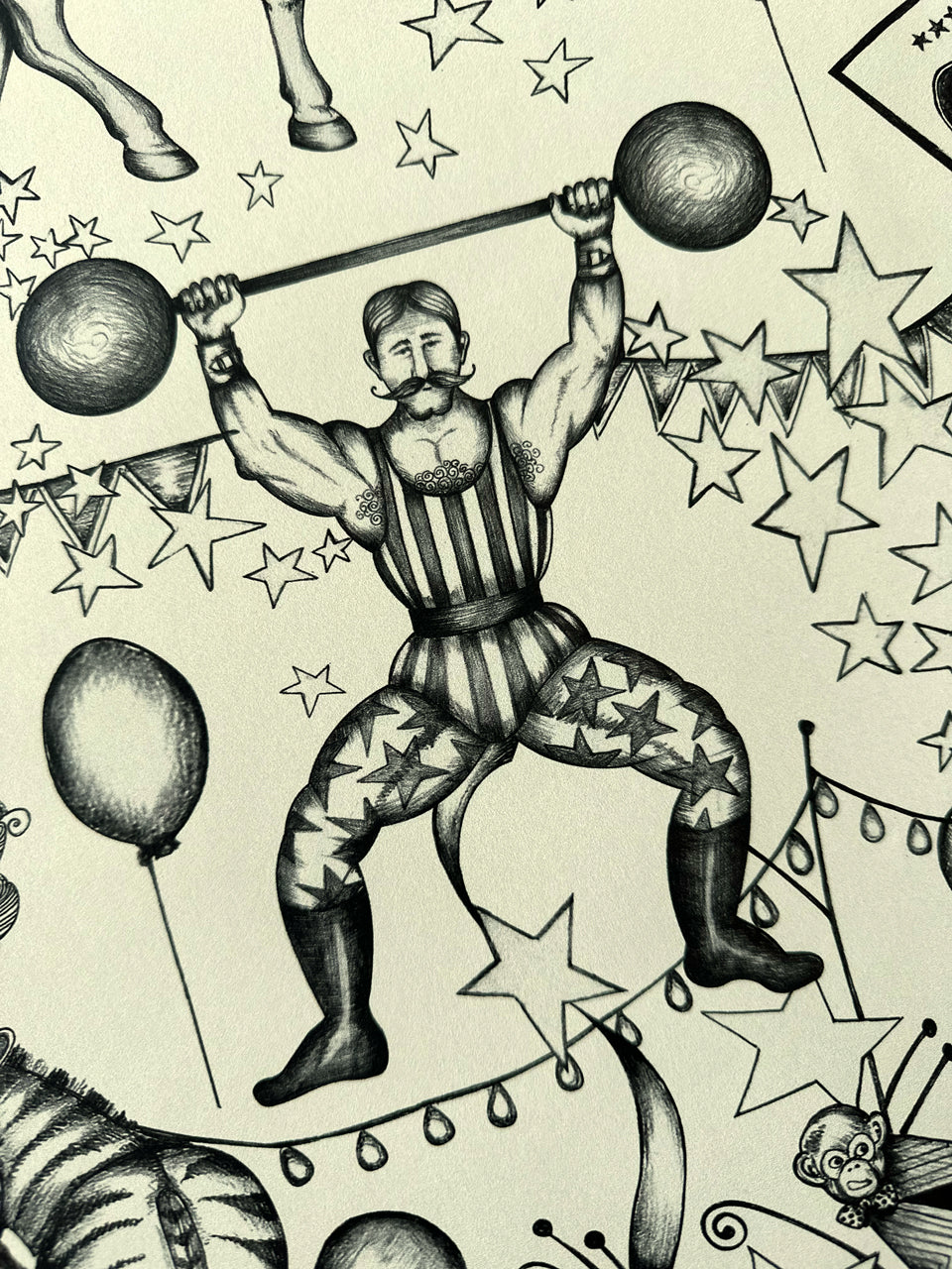 Carnival inspired wallpaper with hand-drawn strongman and star accents in charcoal pencil on cream background.