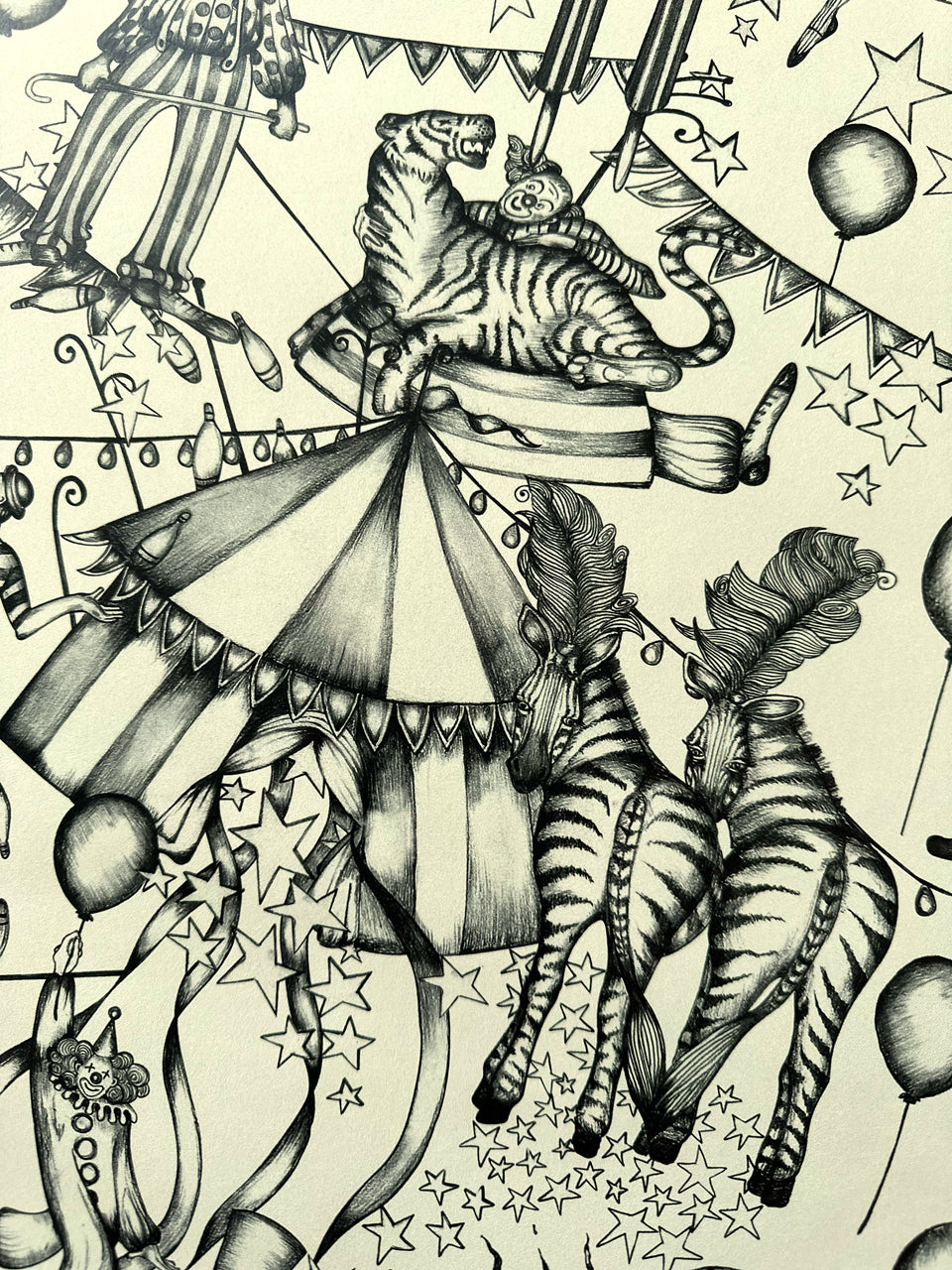 Detailed monochrome illustration of tiger on circus tent with dancing zebras on ivory-toned wallpaper.