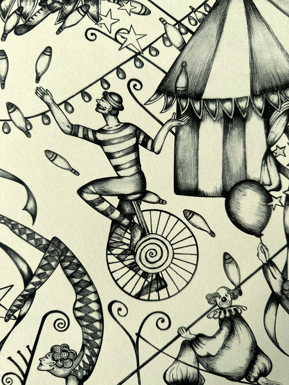 Circus wallpaper with unicycle juggler and clown with stars and bunting on aged paper-coloured ground.