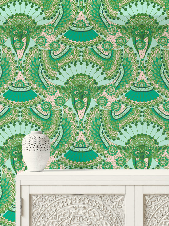 Ornate carved unit against blush pink Indian folk wallpaper with detailed parrot and botanical prints.